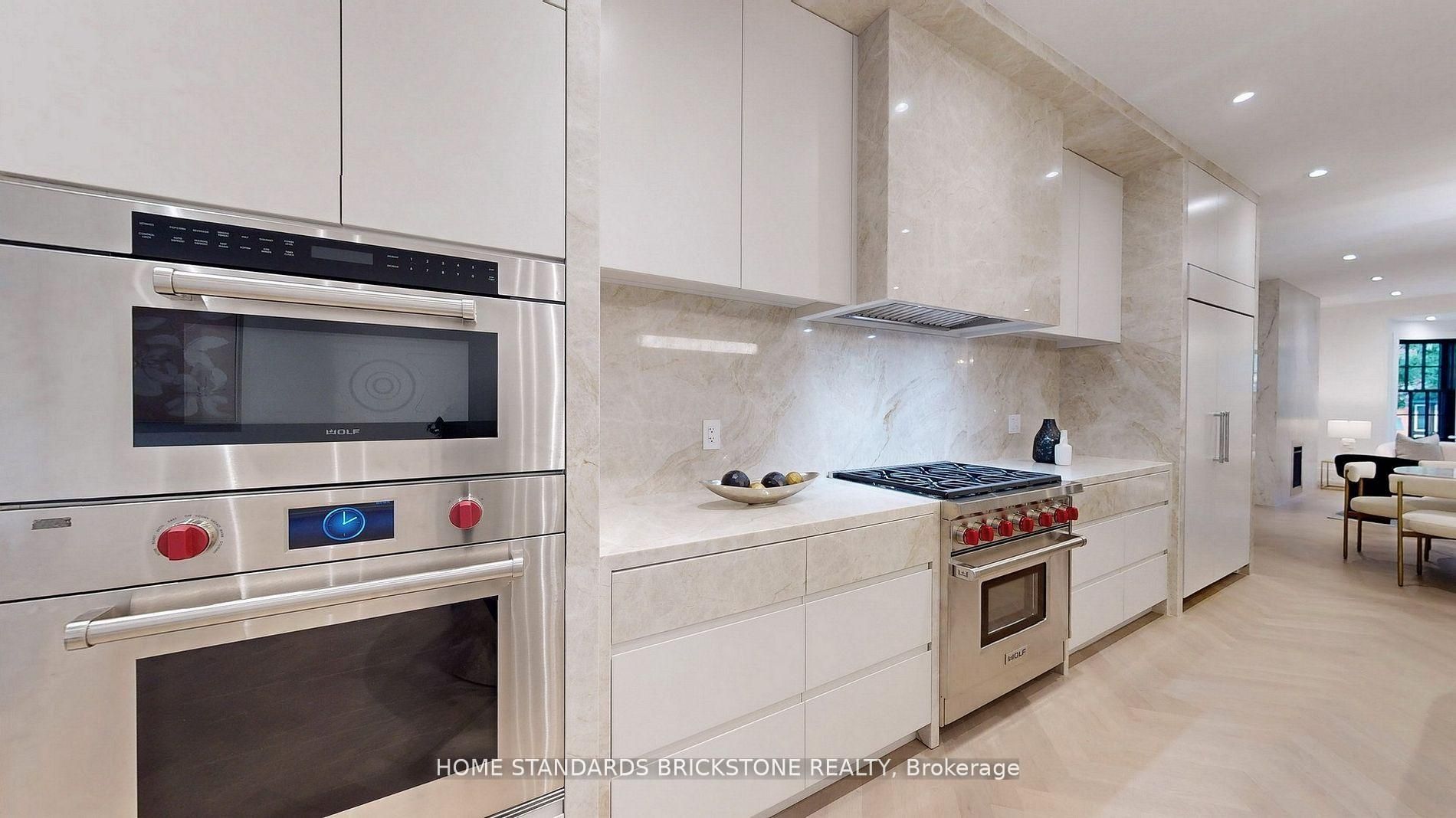 Modern flat-panel kitchen with marble backsplash and professional range