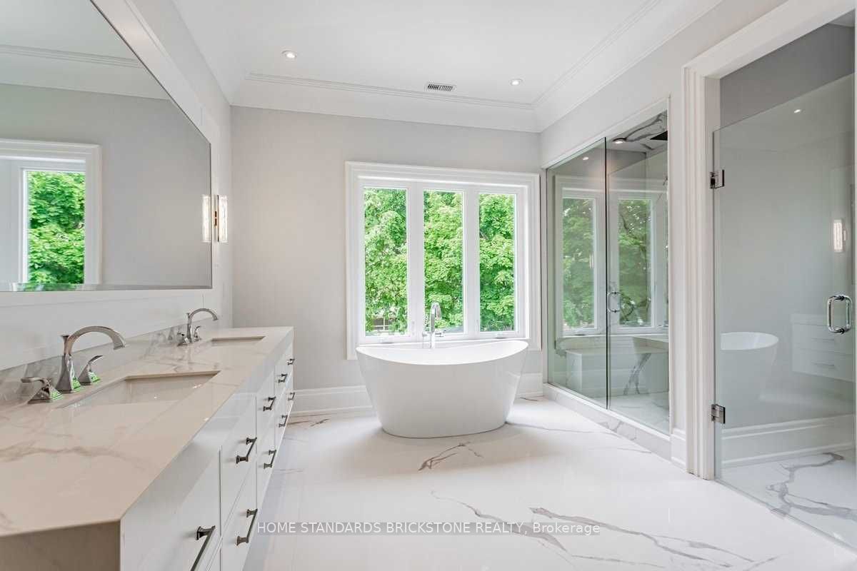 Ensuite bathroom with custom double vanity and freestanding tub