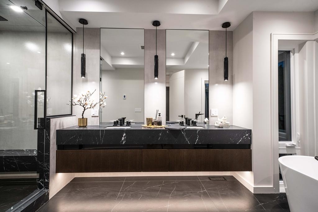 Ensuite with floating black marble double vanity, fluted walnut fronts and pendant lighting — Bedford project
